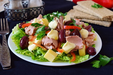 Salad with tuna, olives, cheese, paprika, lettuce and mayonnaise