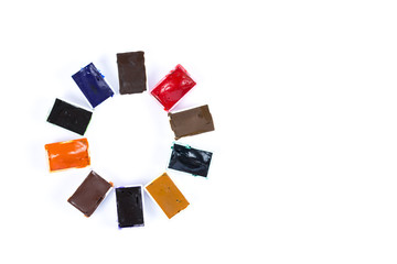 Paints of different colors in white plastic boxes on insulation