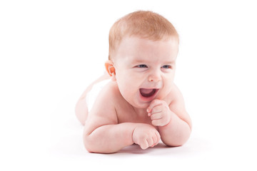 beauty little boy in white diaper lies on belly