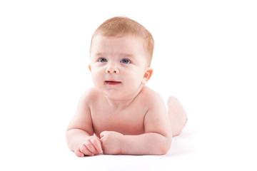 beauty little boy in white diaper lies on belly