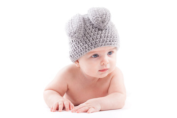 cute pretty baby boy in hair costume lies on tummy