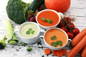 Variety of colorful vegetables cream soups and ingredients for soup. Concept of healthy eating or vegetarian food