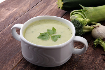 bowl of broccoli cream soup isolated on white background.