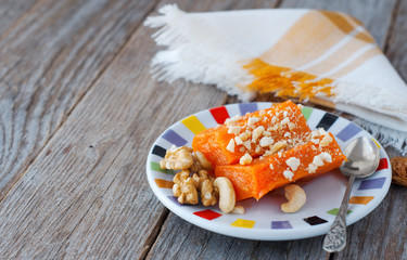 Pieces of sweet baked pumpkin with nuts. The Turkish dish is Kabak Tatlısı.