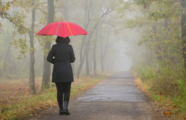 Depressed woman with red umbrella