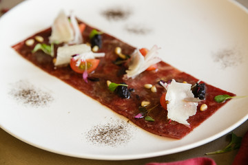 Molecular modern cuisine. tartare or carpaccio of beef. on white.