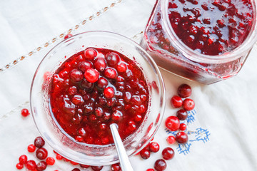 Jam bank with berries top view on a white tablecloth