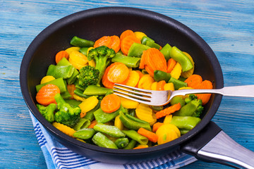 Food for vegetarians. A mix of vegetables on blue background