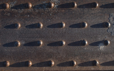 Metal texture. Railway part of rivets and screws of metal plates