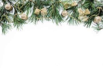 Fototapeta premium Christmas composition with spruce branches, pine cones, Christmas balls and tinsel. Apartment, view from above, christmas wallpaper