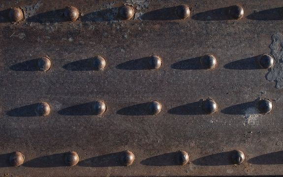 Metal texture. Railway part of rivets and screws of metal plates