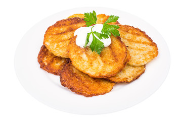 Potato pancakes with white sauce.