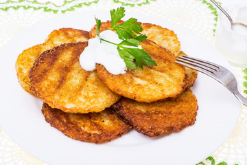 Potato pancakes with white sauce.