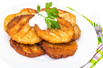 Potato pancakes with white sauce.