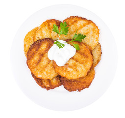 Potato pancakes with white sauce.