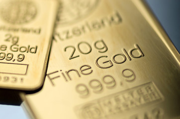 The surface of small minted gold bar. Selective focus.
