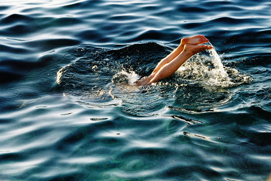 Legs in the sea, splashing.
