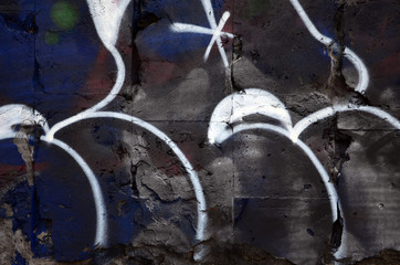 A fragment of graffiti drawing using contours, applied to the wall with the help of cans with...