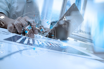 businessman hand working with modern laptop computer in modern office with virtual icon diagram