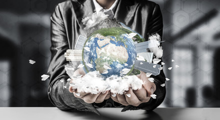 Businessman presenting Earth globe.