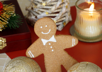 Gingerbread man is playing with Christmas balls
