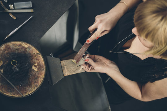 Jewelry designer working on a new piece in her workshop shot from above
