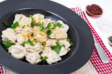 Boiled dumplings in plate on white background