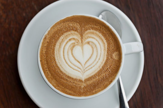 flat white coffee with latte art - Powered by Adobe