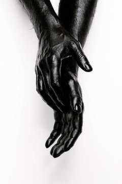 Abstract shot of human hands painted in black