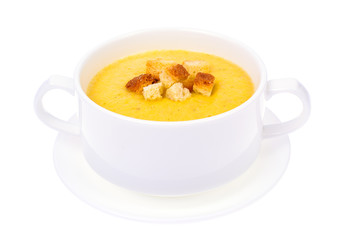Tasty pumpkin puree soup in white soup tureen