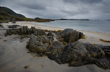 Seascape with stones on the sand shore