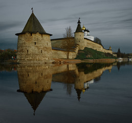 Old fortress in Pskov with its reflection in the water