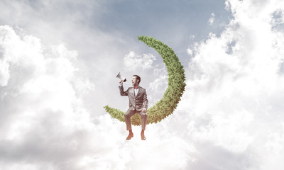 Businessman or manager in blue day sky announcing something in l
