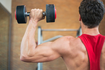 Close up of young man lifting weights