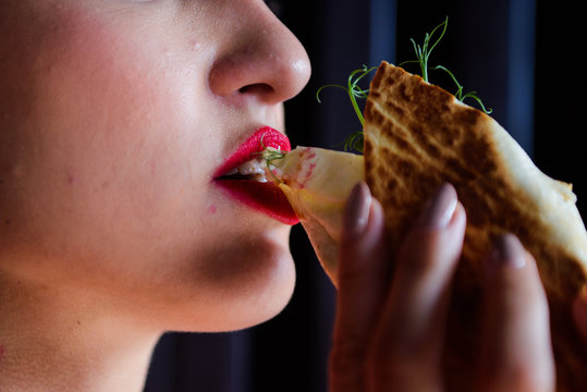 Close-up Of A Person Eating Burritos