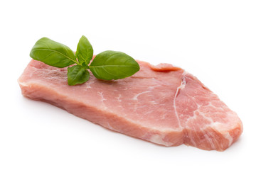 Fresh pork fillet with basil on a white background.