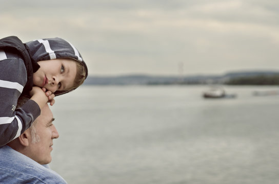 Father and son looking at the river
