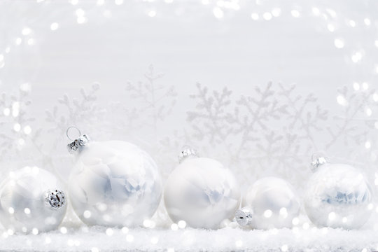 Silver Christmas balls on shiny background.