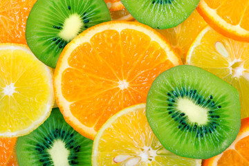 Fruit slices background (lemon, kiwi, orange, tangerine)
