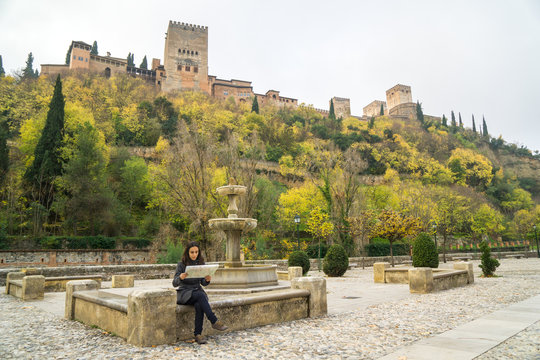 Tourist looking a map next to Alhambra of Granada