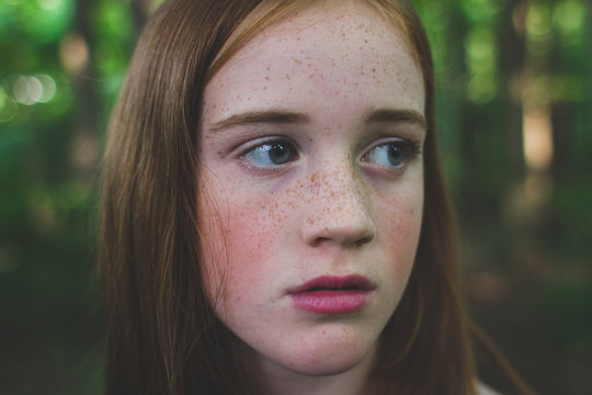 Red Haired girl within trees