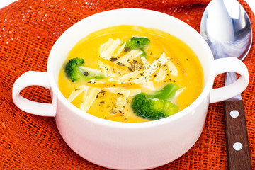 White bowl with chicken cheese broccoli soup