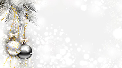 light Christmas background with two holiday evening balls and branch of fir tree