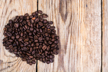 Bunch of coffee beans on wooden table