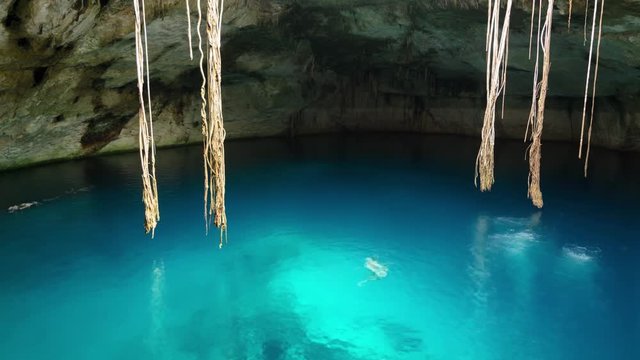Young people swimming in cenote
