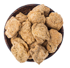 Dry soy slices of meat in wooden plate on white background