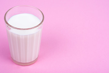 Glass with milk on bright background