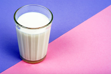 Glass with milk on bright background