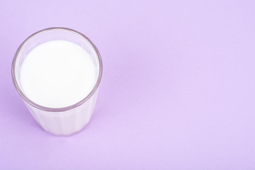 Glass with milk on bright background