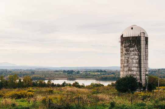 old grain silo overlooking a river